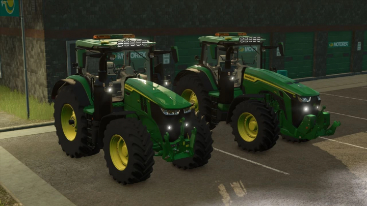fs25-mods,  Two John Deere tractors from the FS25 mods pack in Farming Simulator 25, parked in front of a building at night.