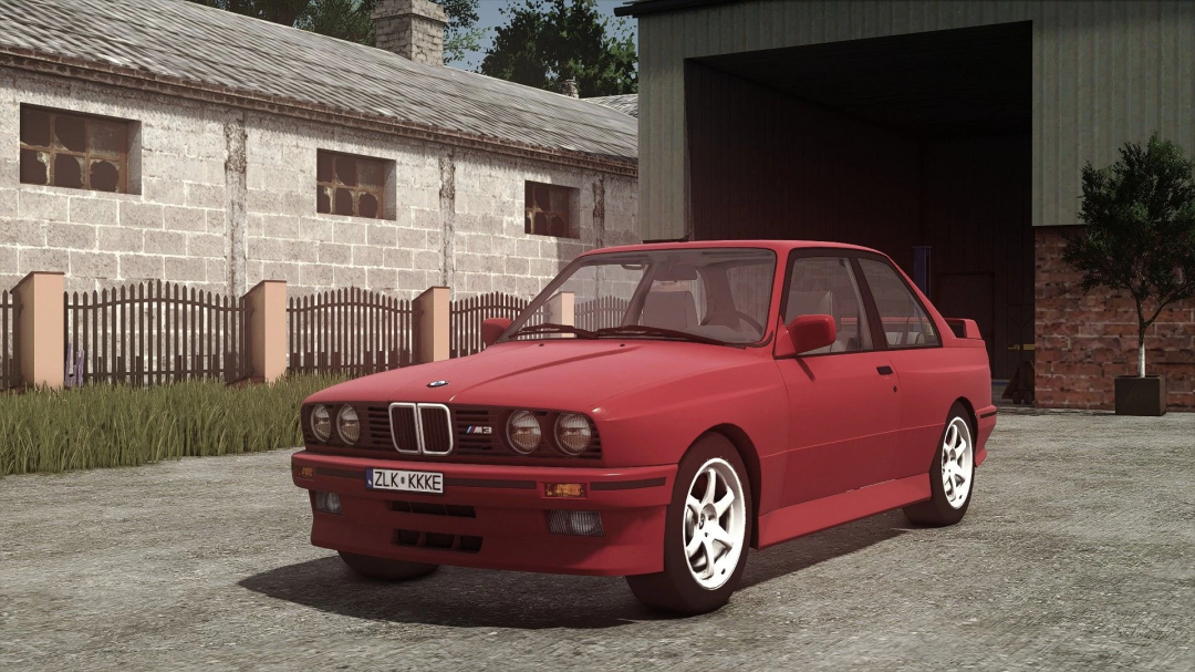 Red BMW M3 E30 Coupe in Farming Simulator 25 mod, parked on a farm yard with barn and shed in the background.