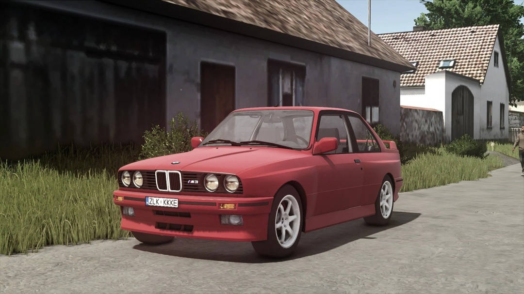 Red BMW M3 E30 Coupe mod from Farming Simulator 25, parked on a rural street with grass and houses in the background.