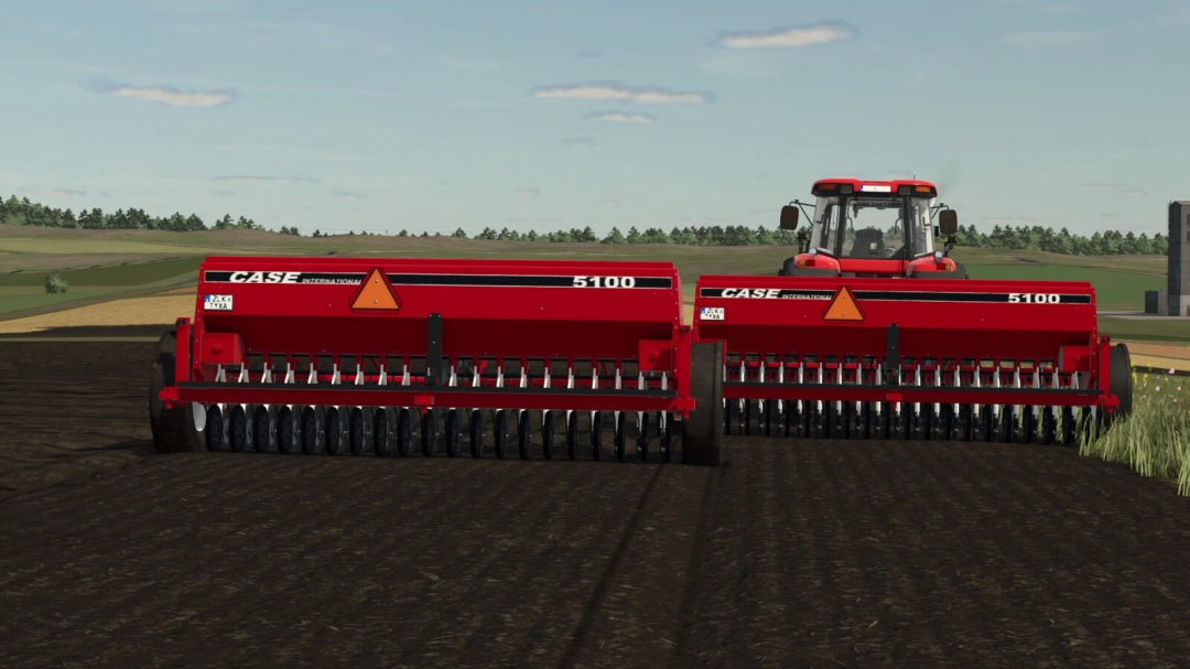 Farming Simulator 25 mods: red Case 5100 seed drill attachment on farmland in FS25 game.