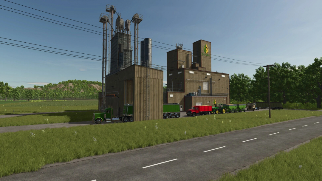 Farm building in Farming Simulator 25 featuring ethanol and feed production with trucks, set outdoors with green trees and blue sky.