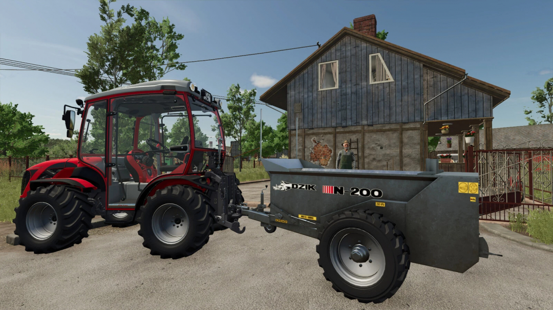 Farming Simulator 25 mod: Red tractor with Cynkomet Dzik N-200 trailer parked outside a rural house.