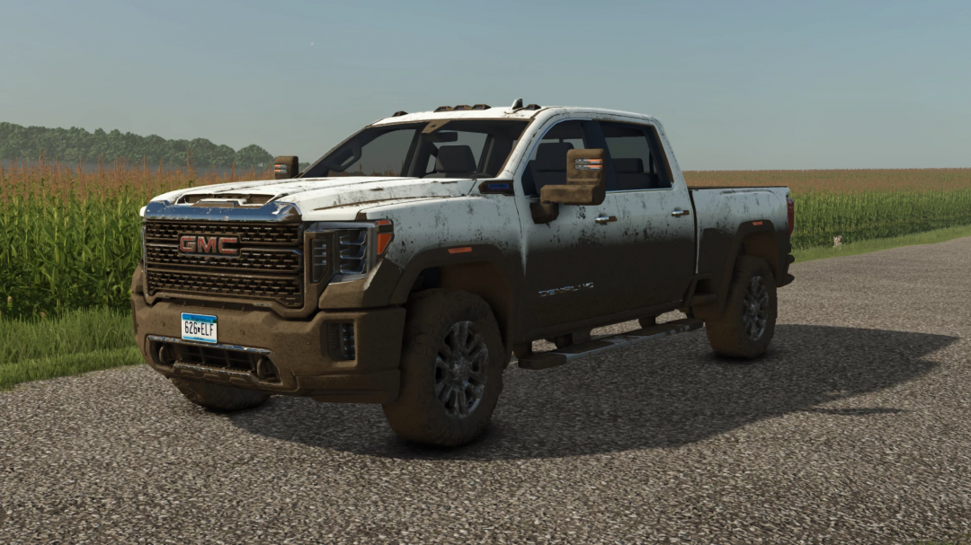 Farming Simulator 25 mod: GMG Sierra Denali 2500 pickup truck with dirt and mud details, displayed on a rural road.