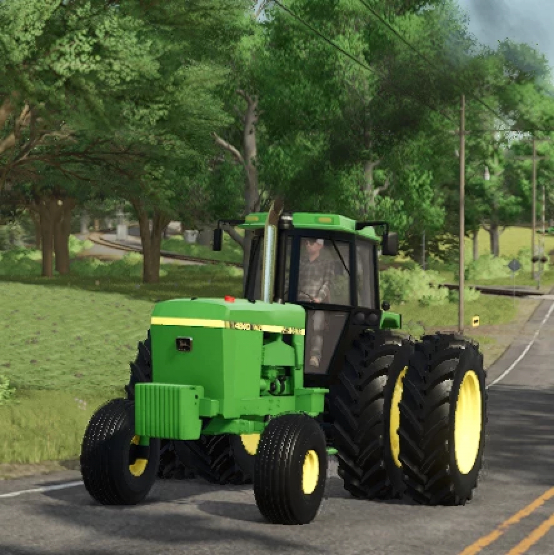 Farming Simulator 25 mod featuring a detailed green John Deere 4840 tractor on a rural road, highlighting FS25 mods for realistic gameplay.