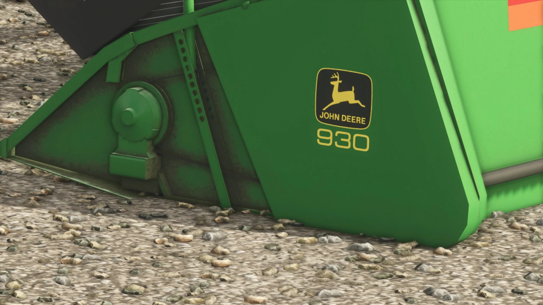 Close-up of a green John Deere 930 farming equipment mod from FS25, resting on gravel ground.