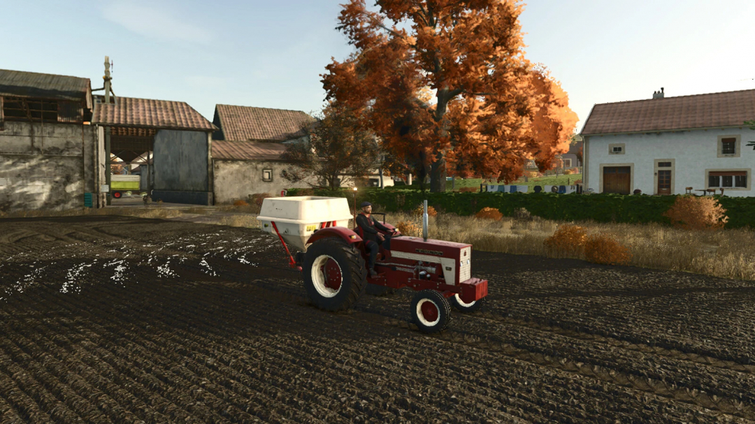 Farming Simulator 25 mod: IH MC Cormick 423 tractor plowing a field with autumn trees in the background.