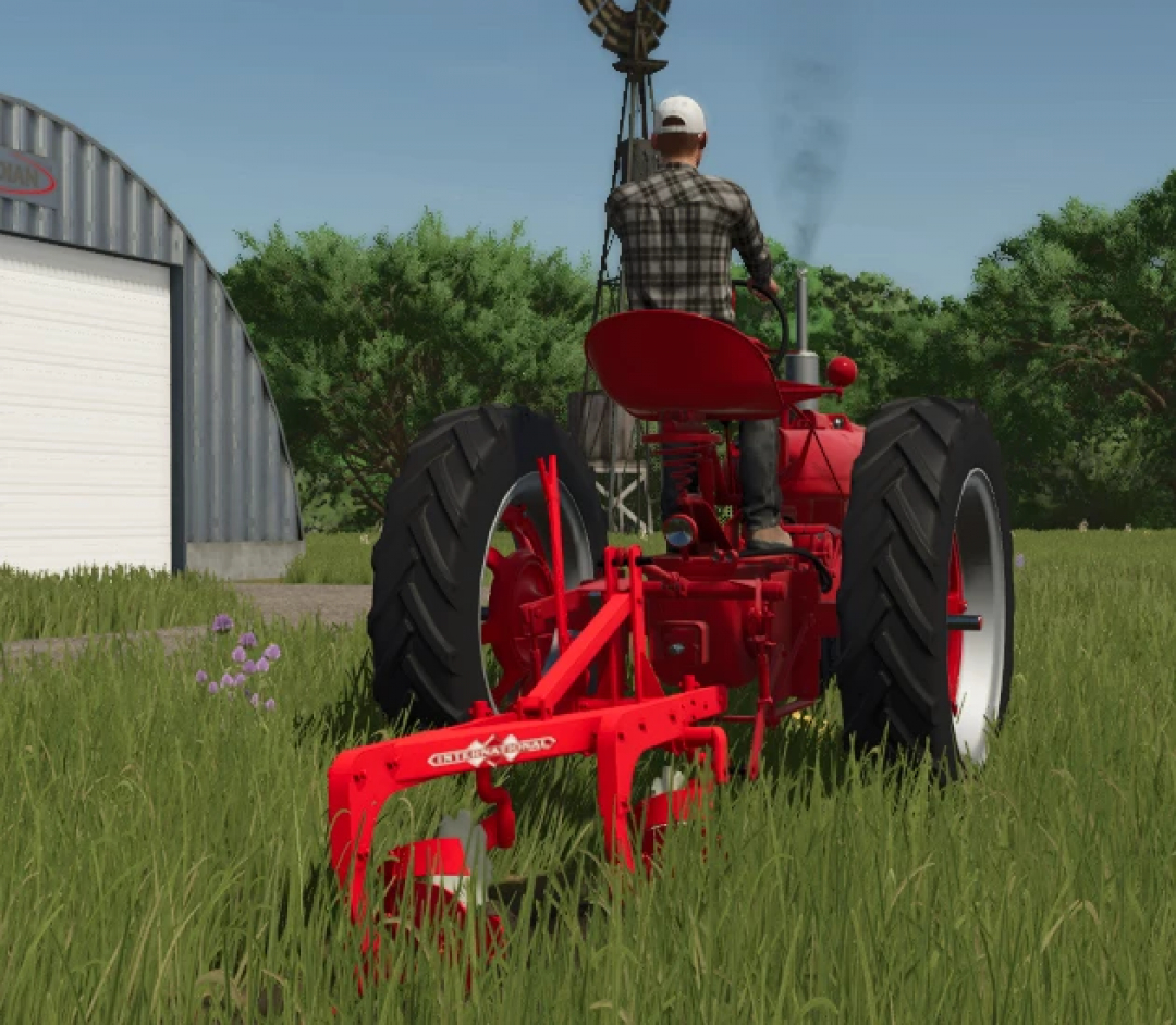 Farming Simulator 25 mod: Red vintage tractor with plow attachment in a grassy field, featuring the International Plow v1.0.0.0.
