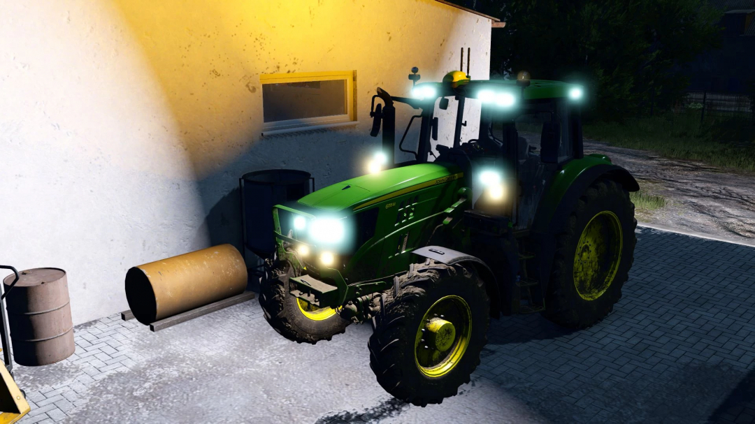 Farming Simulator 25 mod: Green John Deere 6155M MY2020 tractor with illuminated headlights parked near a building, part of FS25 mods.