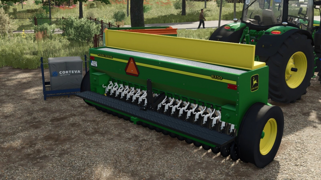 Farming Simulator 25 mod: John Deere 8350 seed drill attached to a tractor in a farm setting.