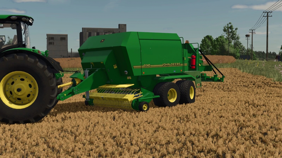 Farming Simulator 25 mod: John Deere 690 baler attached to tractor on a wheat field.
