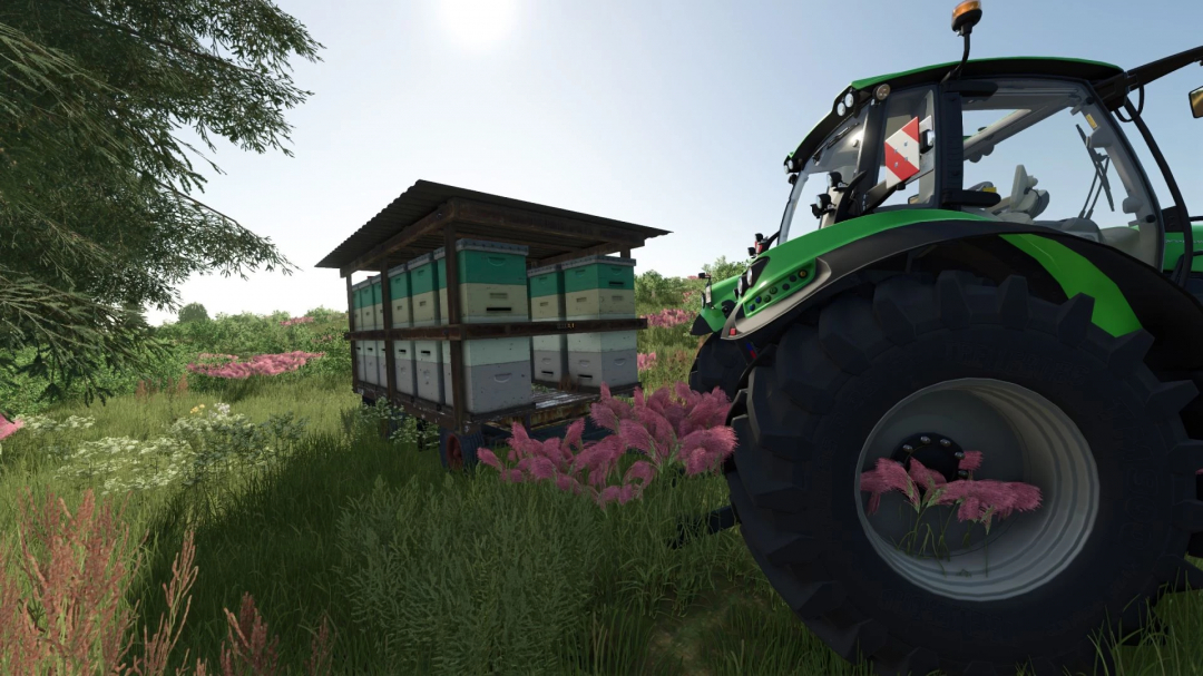 Farming Simulator 25 mods: Old trailer with beehives v1.0.0.0, parked in a grassy field with pink and white flowers, next to a tractor with bee hives.