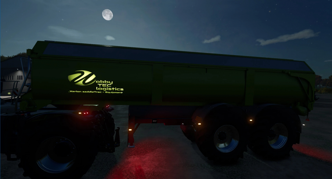 Night view of the Farming Simulator 25 mod SaddleTrac Trailer v1.0.0.0 with illuminated logo, part of FS25 mods collection.