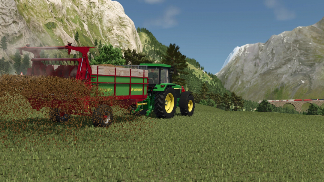 Farming Simulator 25 mod showcasing the Strautmann Streublitz BE 5 forage wagon in a scenic mountain field.