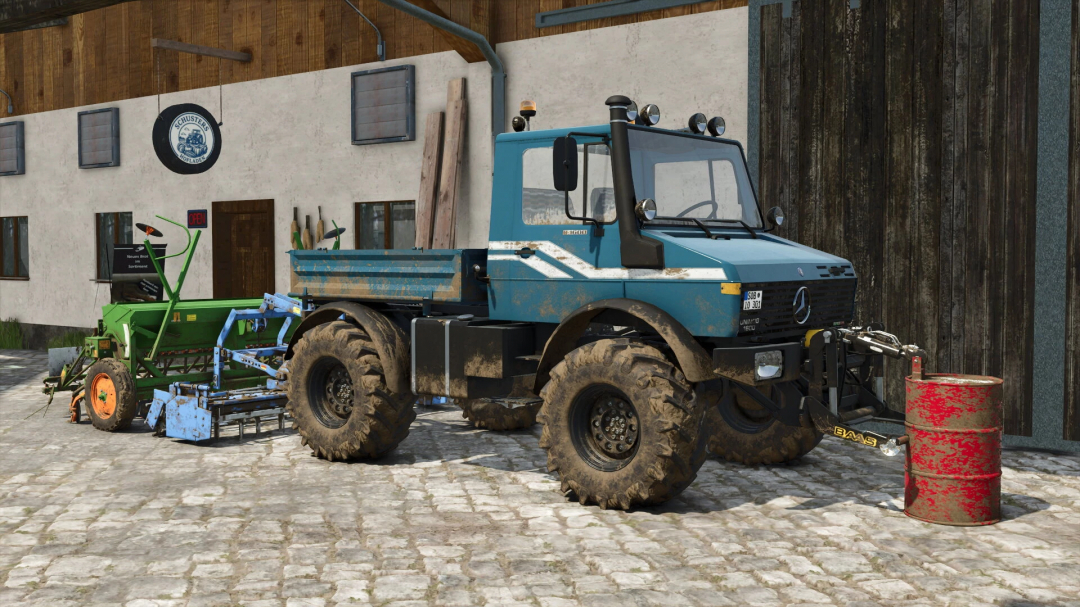 Farming Simulator 25 mod featuring a blue Unimog U1200 utility vehicle with attachments, dirt on tires, and a rusty drum in a farm setting.