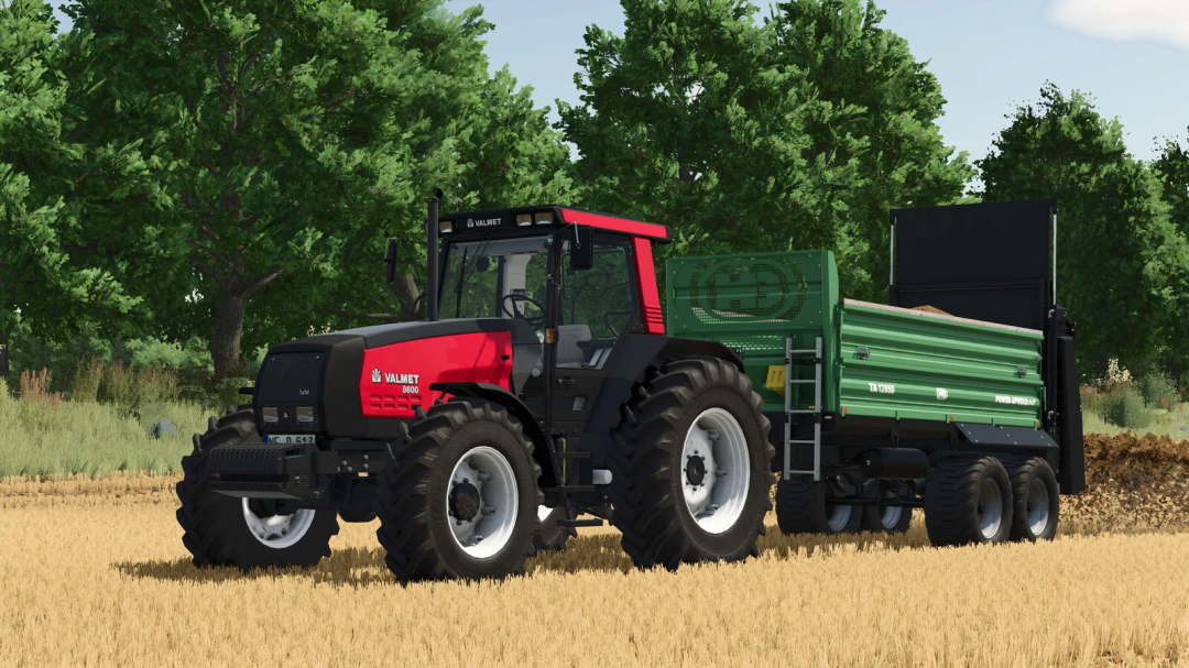 Farming Simulator 25 mods: Valmet MEGA 8300-8800 Series tractor with green trailer, on farmland with trees in the background.