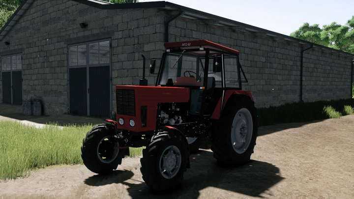 fs25-mods,  Farming Simulator 25 mod: Belarus 82MK tractor parked outside a barn with green grass and dirt ground.