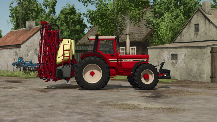 fs25-mods,  Farming Simulator 25 mod: International 1255 XL tractor with spraying equipment on a farmyard.