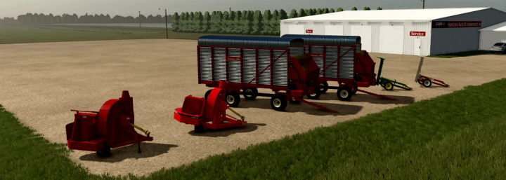fs25-mods,  Farming Simulator 25 mods: New Holland F62B Silage Blower v1.0.0.0, red silage equipment and trailers on a farm near a workshop building.