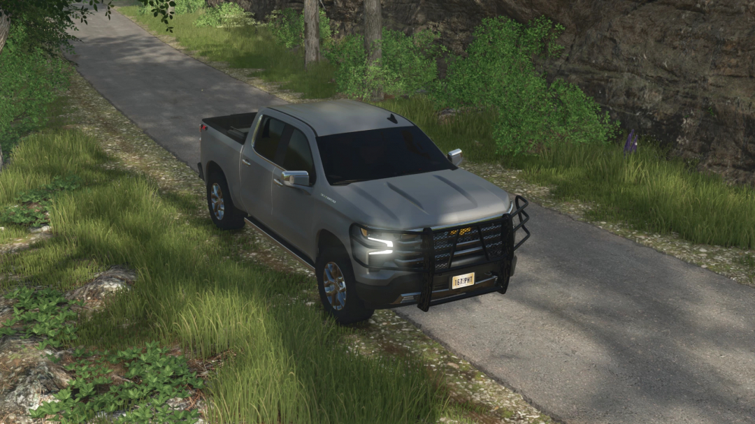 In-game image of a silver Chevrolet Silverado 1500 with a black front grille guard, parked on a rural road in Farming Simulator 25 with FS25 mods.