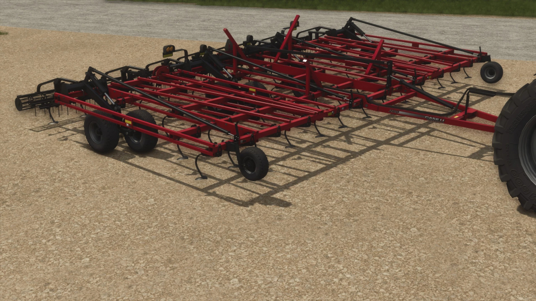 Farming Simulator 25 mods: Case IH Tigermate 200 cultivator on a sandy field, detailed view of the red and black farming equipment.