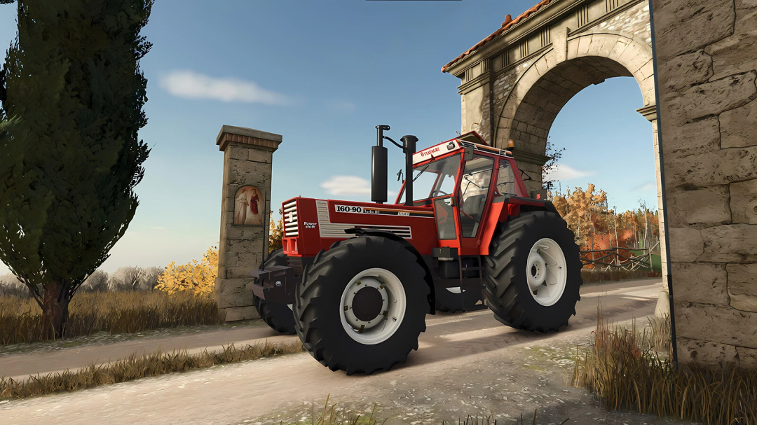 Farming Simulator 25 mod: Fiatagri Series 90 v1.0.0.0 tractor in front of a stone archway with autumn scenery.