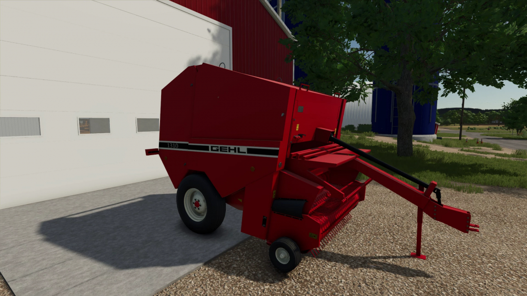 FS25 mod Gehl 1310 Round Baler in Farming Simulator 25, red round baler on farm ground near a white barn and trees.