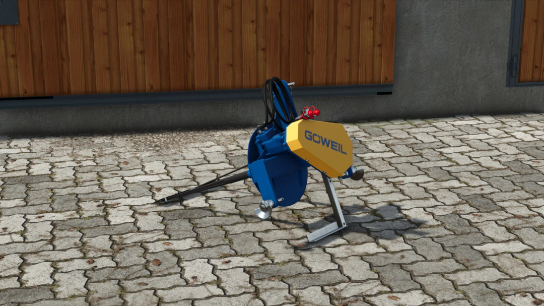 Farming Simulator 25 mod: Göweil BZT v1.0.0.0, a machinery tool placed outdoors on a cobblestone surface near a wooden building.