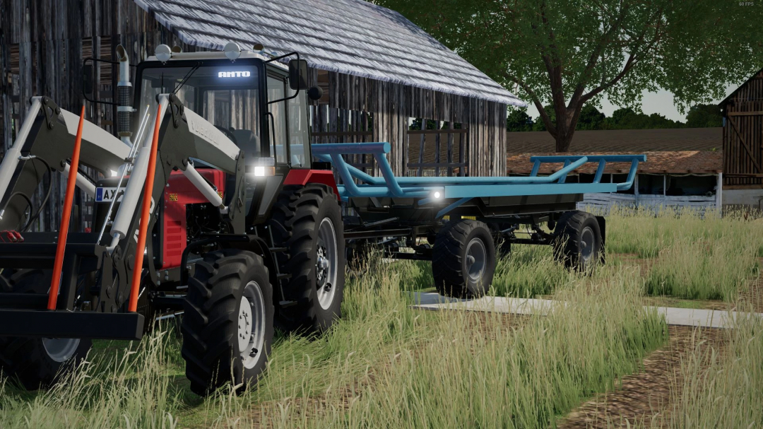 Farming Simulator 22 mod: HW80 HUN Bale Trailer v1.0.0.0 attached to a tractor on a farmyard with barns and grassy fields.
