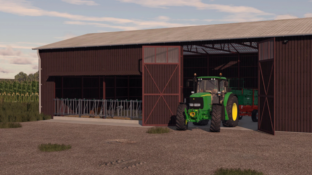 Farming Simulator 25 mod: Green tractor inside a barn with cow pens, part of the Hall CowBarn v1.0.0.0 in FS25 mods.