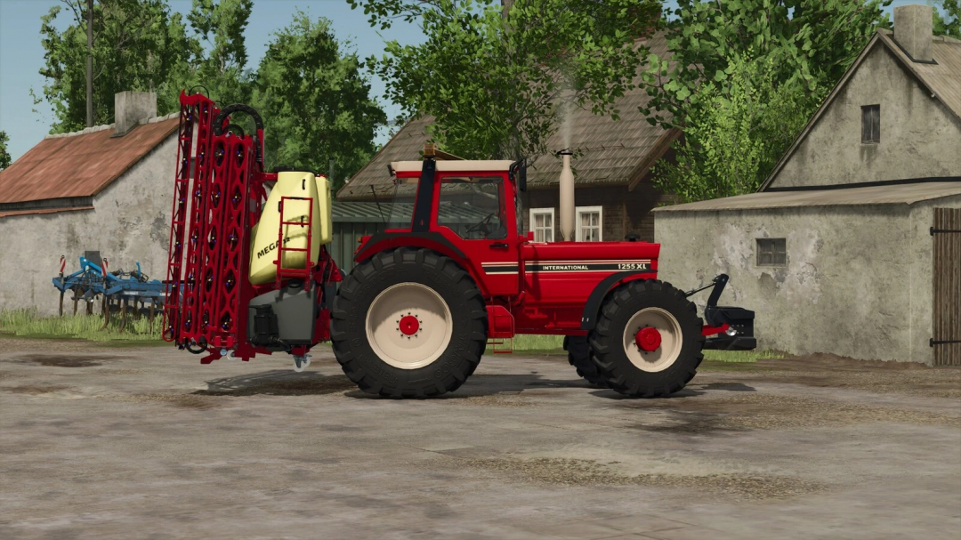 Farming Simulator 25 mod: International 1255 XL tractor with spraying equipment on a farmyard.