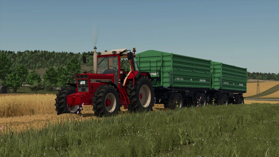 Farming Simulator 25 mod: Red tractor pulling a large green trailer in a field, part of the International 1455/1255 XL mod pack.