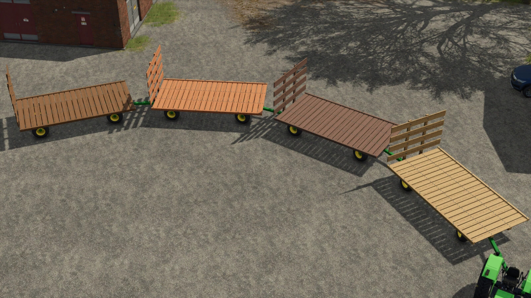 John Deere 1075 Hay Wagon v1.0.0.0 in Farming Simulator 25, featuring multiple wooden trailers with green axles and wheels, parked on a gravel lot.