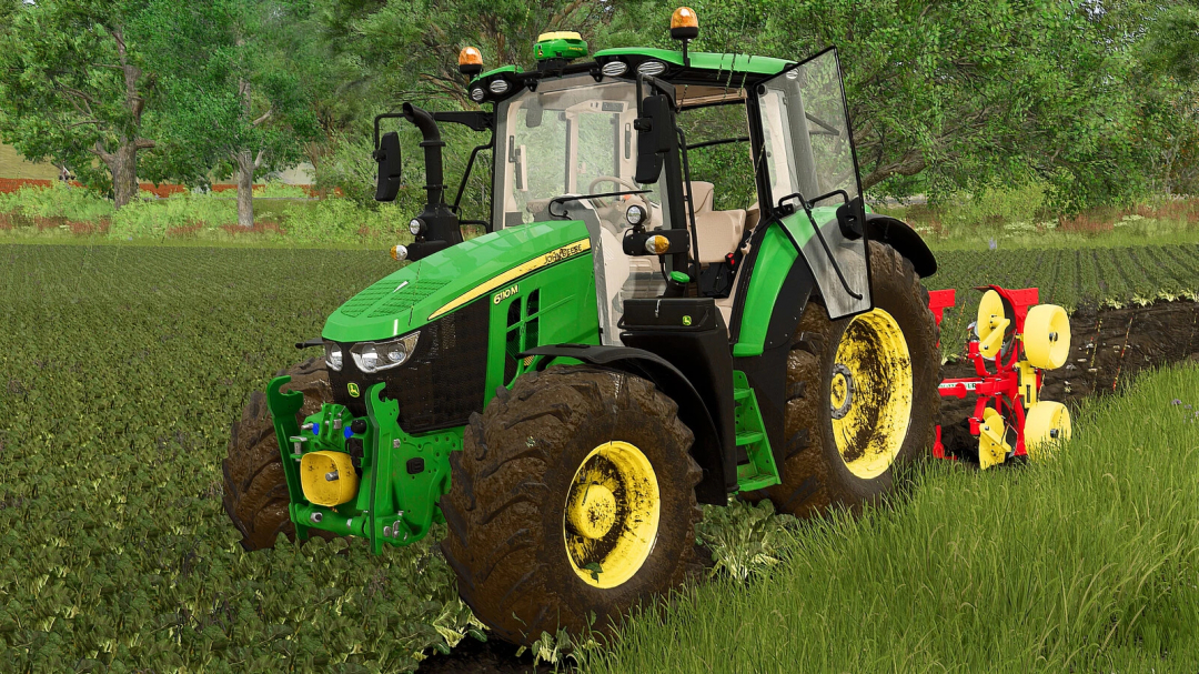 John Deere 6M Series tractor from FS25 mods working in a green field, with farming equipment attached, for Farming Simulator 25.