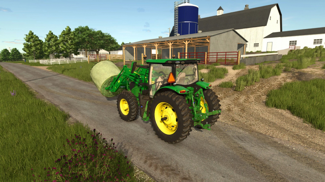 Farming Simulator 25 mod: John Deere 6R mid-sized tractor hauling hay bale on a farm road.