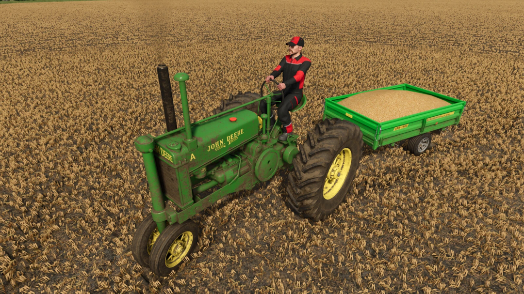 Farming Simulator 25 mod: John Deere Model A on a plowed field pulling a grain trailer loaded with harvested crop.