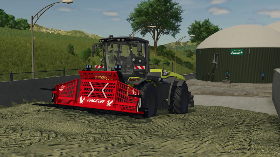 Farming Simulator 25 mod: Claas Xerion tractor with MDE Falcon FT16 v1.0.0.0 attachment, working on a farm area with green fields and storage tanks.