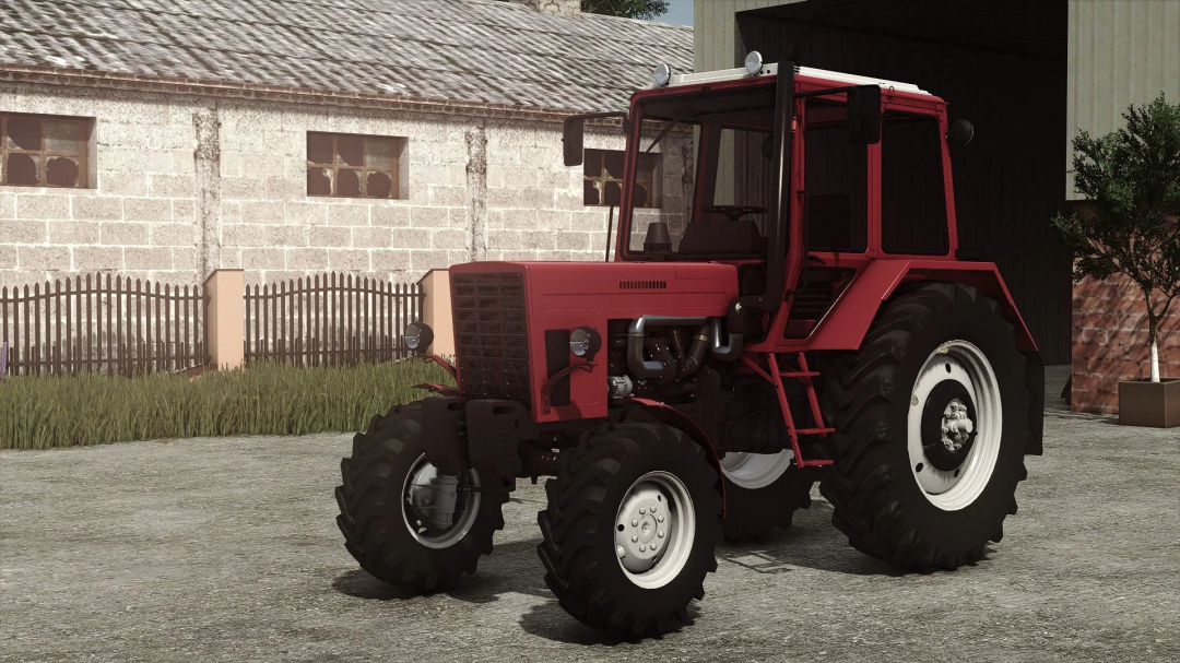 Farming Simulator 25 mod: Red MTZ 82UK MB tractor with large rear tires parked outside a farm building.