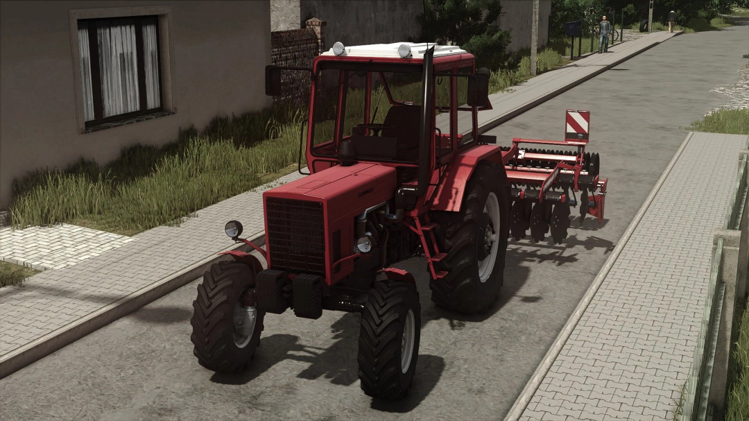Farming Simulator 25 mod: MTZ 82UK MB tractor with attached tillage implement on a village street.