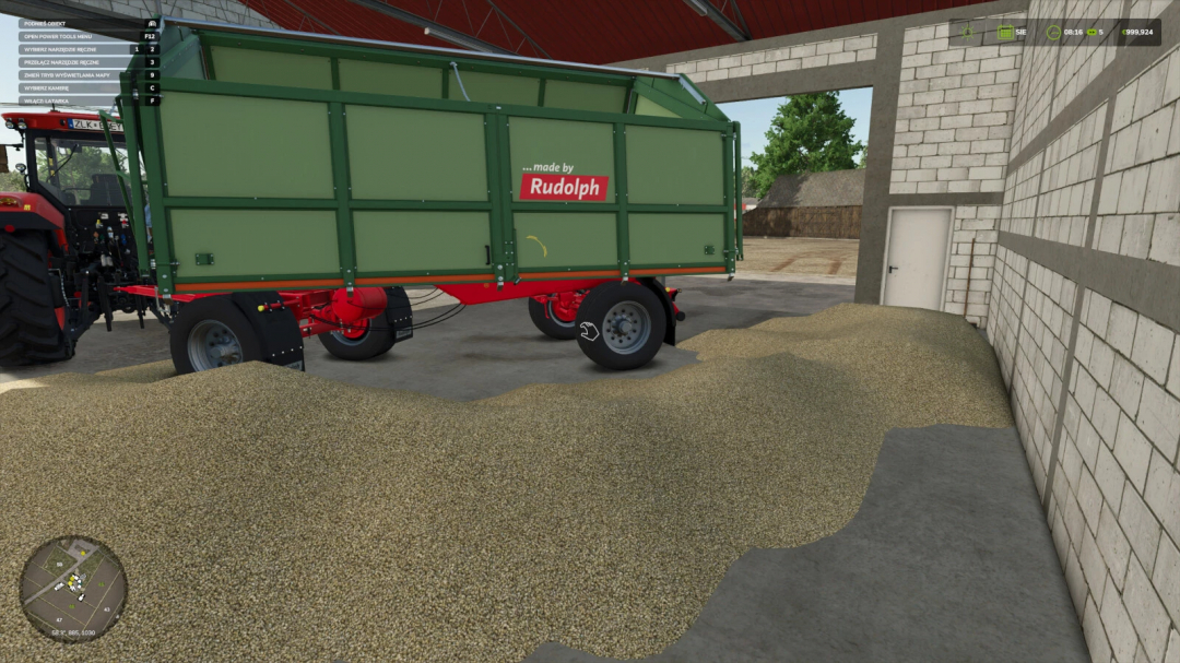 Farming Simulator 25 mod: Green manure trailer with 'made by Rudolph' label, parked inside a barn with a pile of grain nearby.