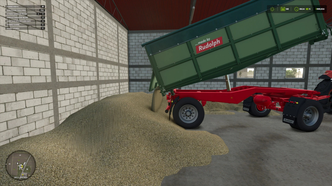 Agricultural trailer from Farming Simulator 25, lifted to pour grains onto the floor inside a barn, featuring a 'made by Rudolph' label.