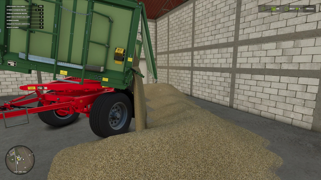 Farming Simulator 25 mod: Green trailer with manual tipping feature, unloading a pile of grain inside a barn, part of Farming Simulator 25 mods.