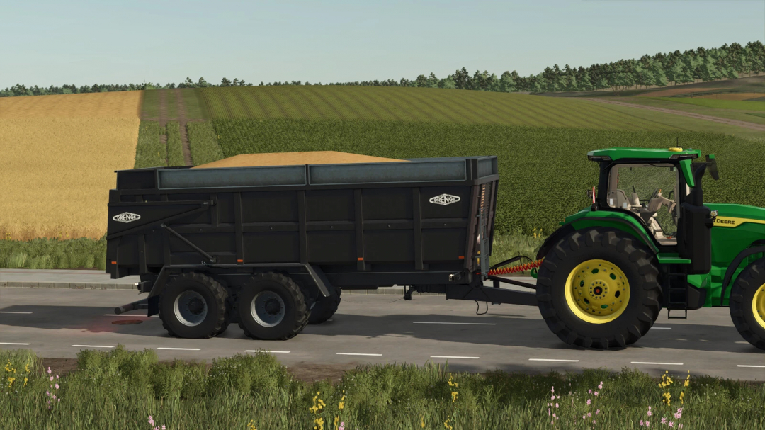 Farming Simulator 25 mod: Green tractor towing a black Orenge ORM 180 v1.0.0.0 trailer on a rural road with fields in the background.