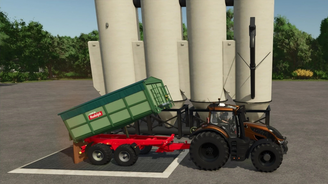 FS25 mod: Tractor with Pigfood Production trailer near silo in Farming Simulator 25.