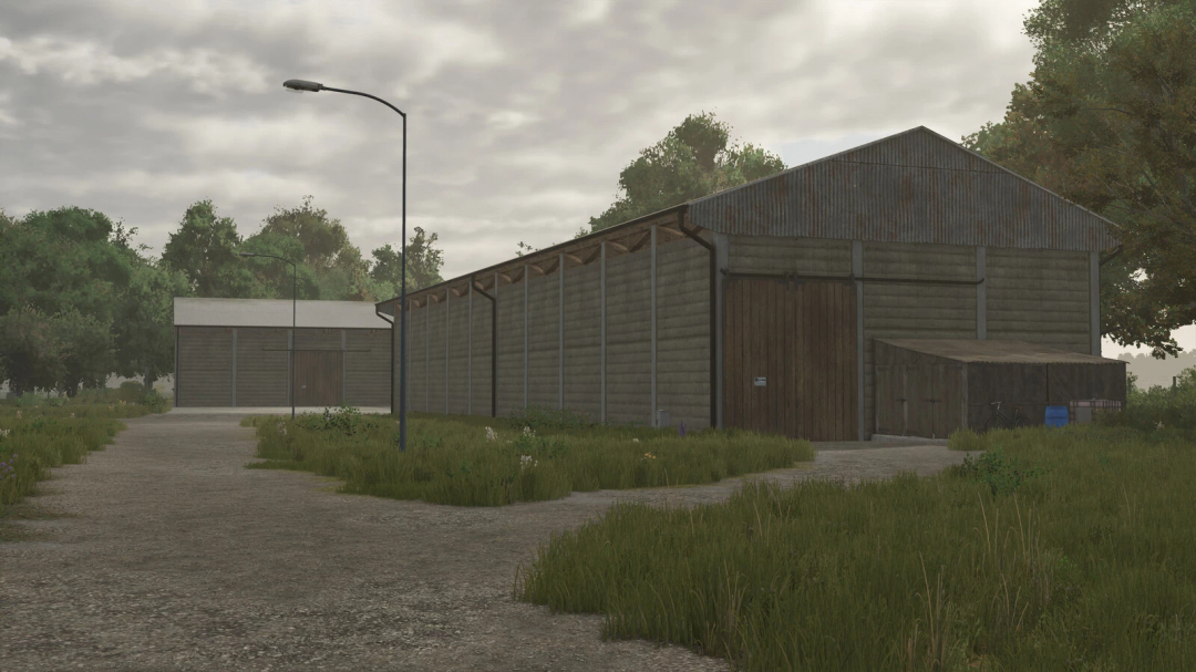 In-game image of a rustic salvage hall with grassy surroundings and street lamps, from Farming Simulator 25 mods, Salvage Halls Package v1.2.0.0.