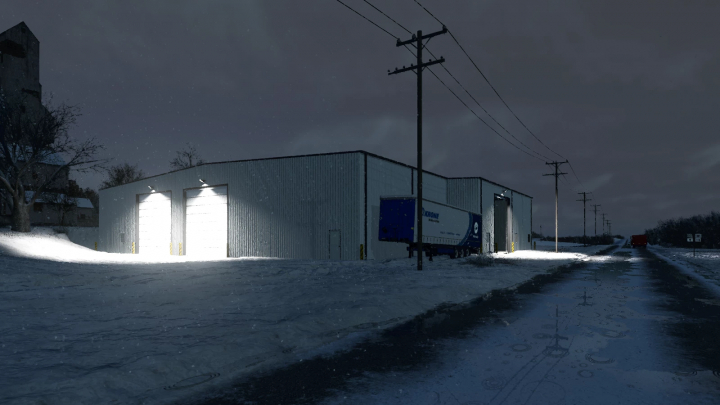 fs25-mods,  Night scene of a metal shop building with bright garage doors illuminated, surrounded by snow and power lines, in Farming Simulator 25 mods.
