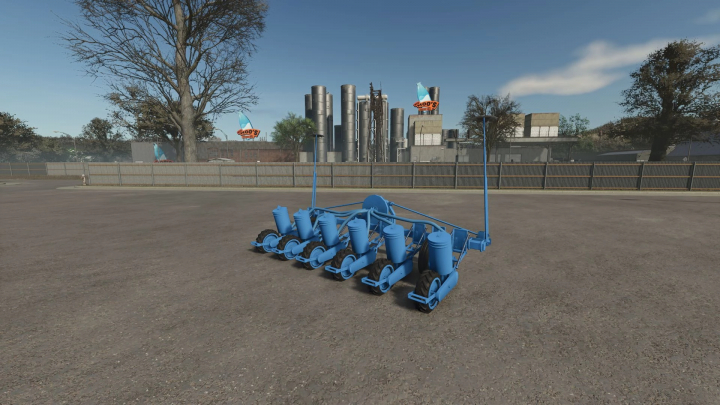 fs25-mods,  Farming Simulator 25 mod, SPC-6 v1.0.0.0, blue agricultural equipment on a dirt lot, with industrial buildings and trees in the background.