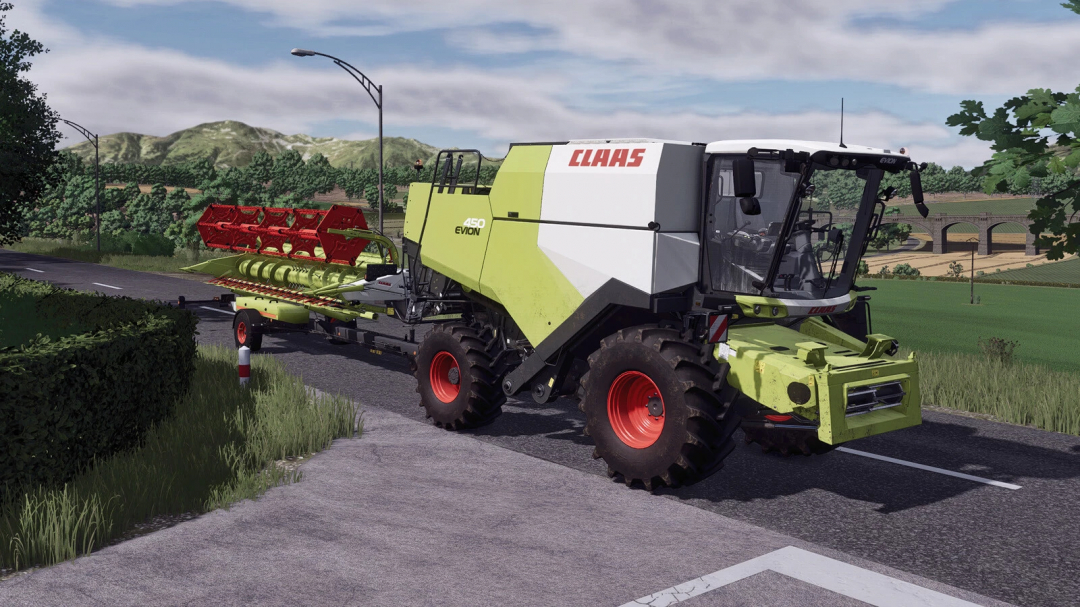 CLAAS Evion 450 Pack v1.0.0.0 mod in Farming Simulator 25, large green and white harvesting machine on a rural road with landscape backdrop.