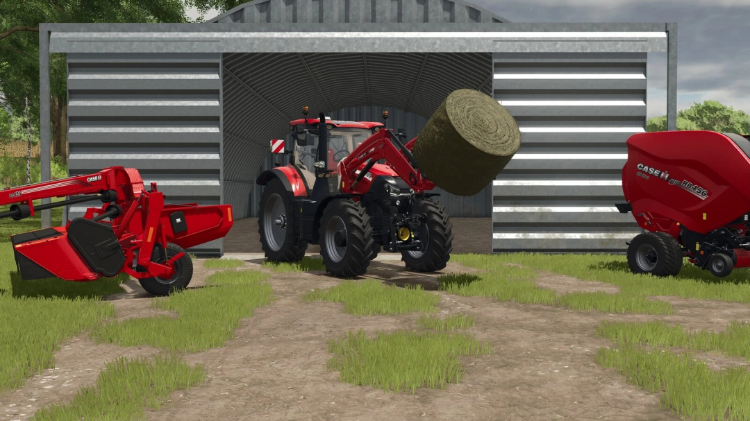 Farming Simulator 25 mods: Red tractor with loader lifting a hay bale outside a metal barn, with manure spreader on the right.