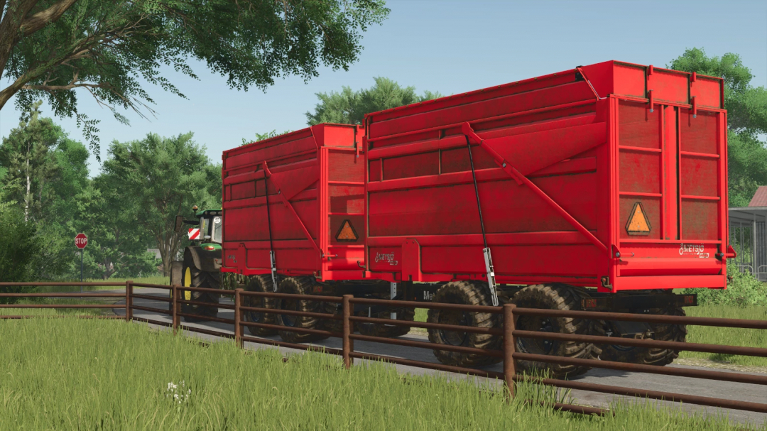 Farming Simulator 25 mod: Red Metsjö MetaQ 60 trailer attached to a tractor, positioned next to a rural road with trees and a stop sign.