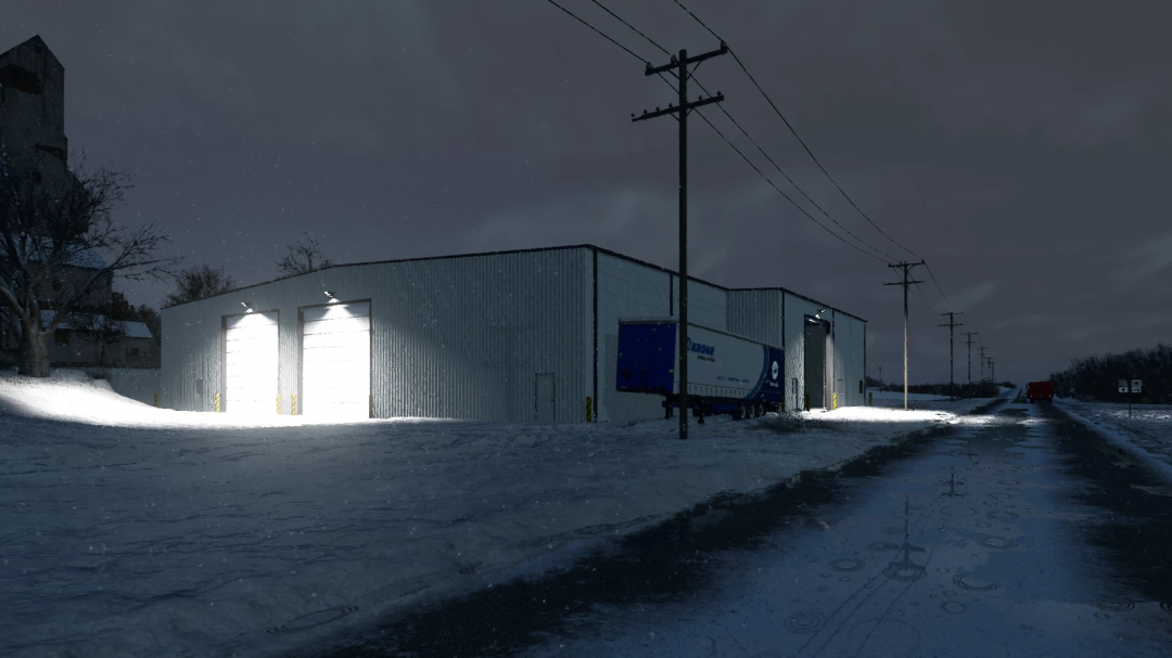 Night scene of a metal shop building with bright garage doors illuminated, surrounded by snow and power lines, in Farming Simulator 25 mods.